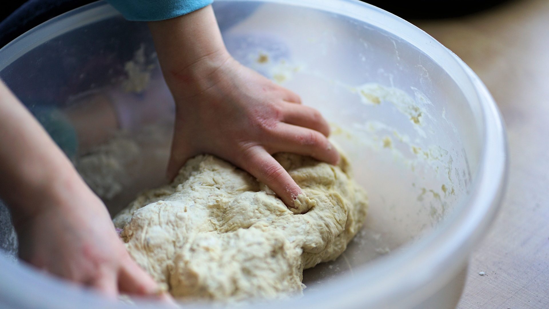 Child's hands kneading dough
