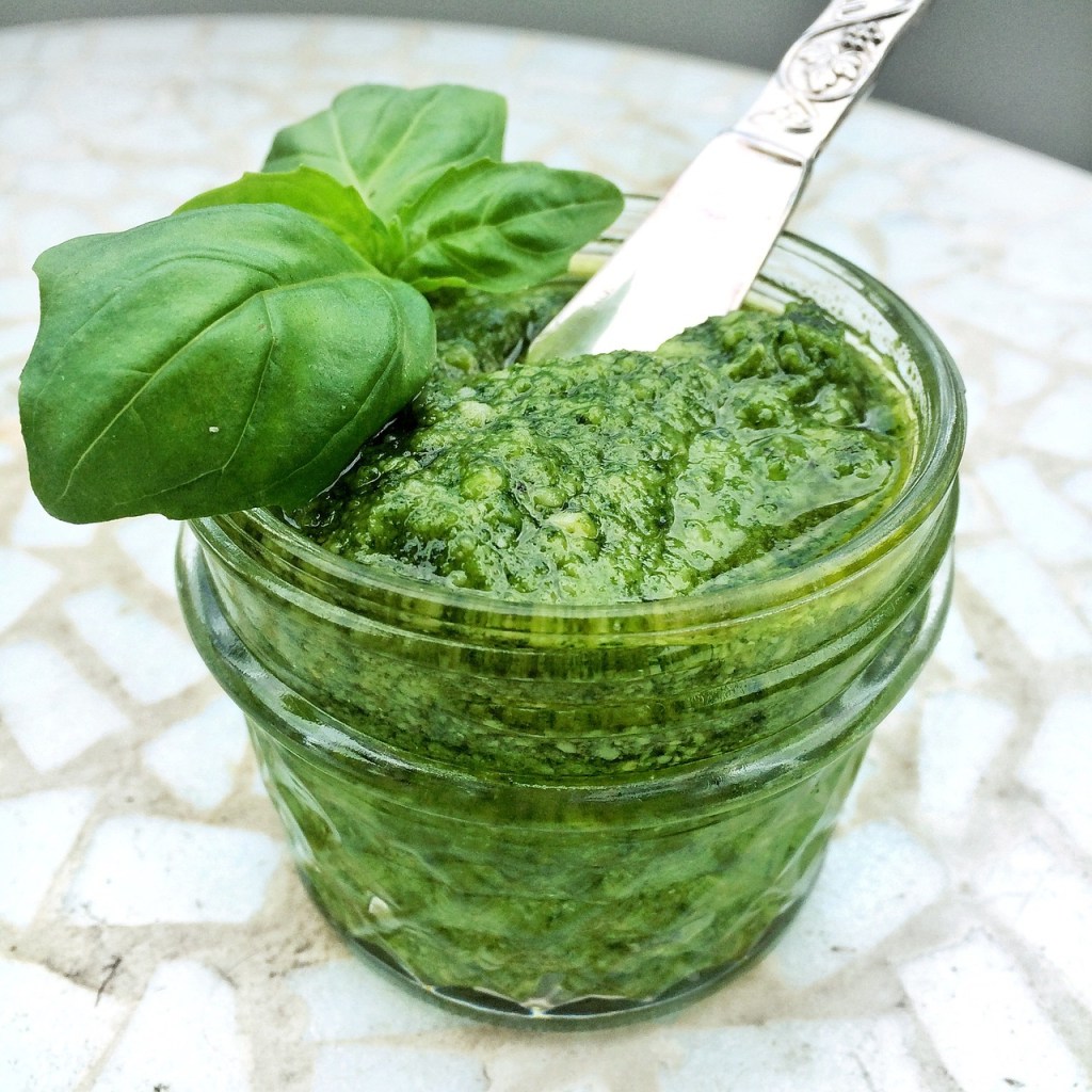 Jar of pesto with basil garnish