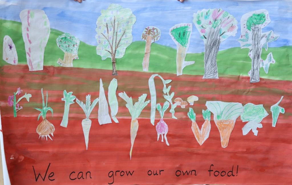Art mural with trees and vegetables drawn by children