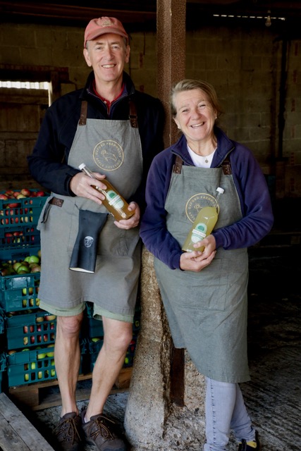Founders Andrew and Mandy holding bottles of juice